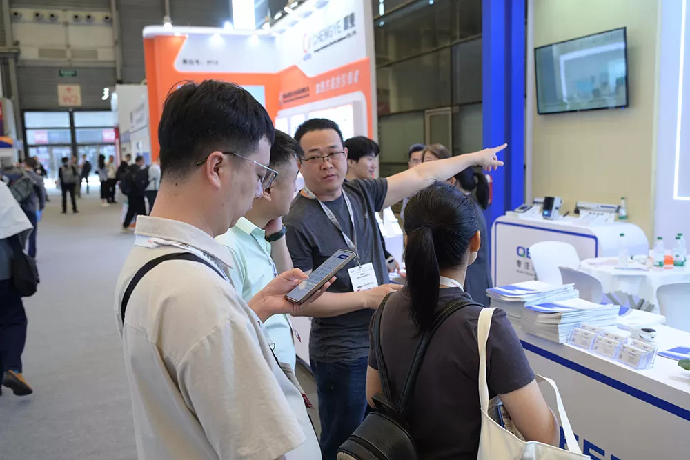 A collage from the QEEPO booth at Productronica China, showing staff demonstrating static control products to interested local and international attendees.