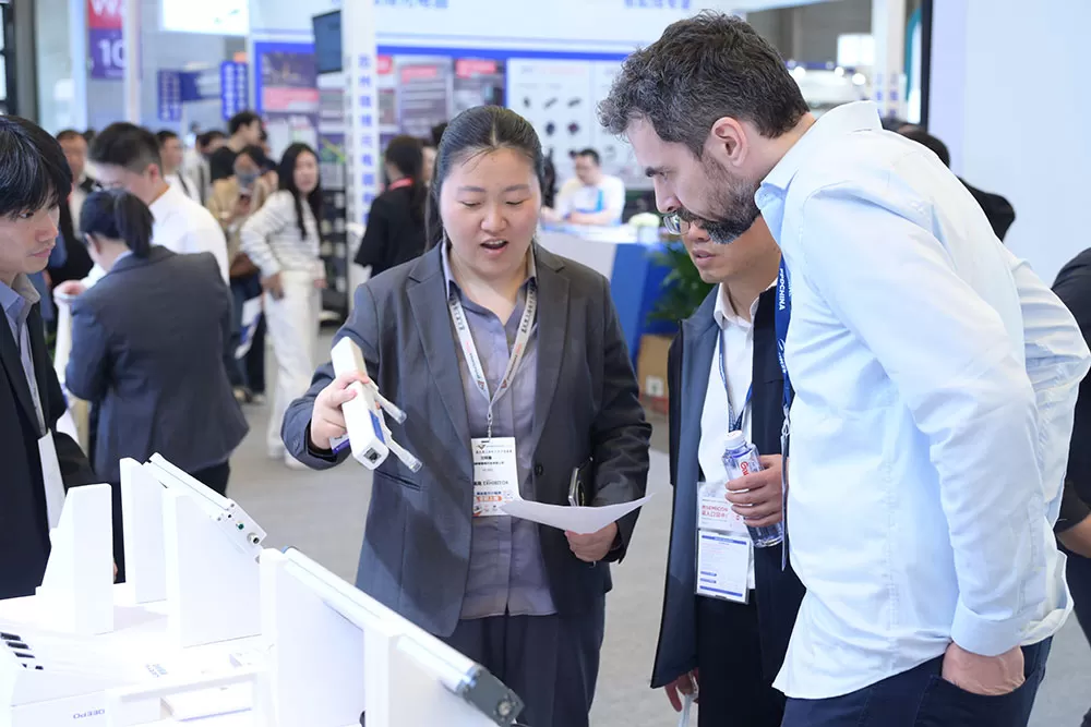A collage from the QEEPO booth at Productronica China, showing staff demonstrating static control products to interested local and international attendees.